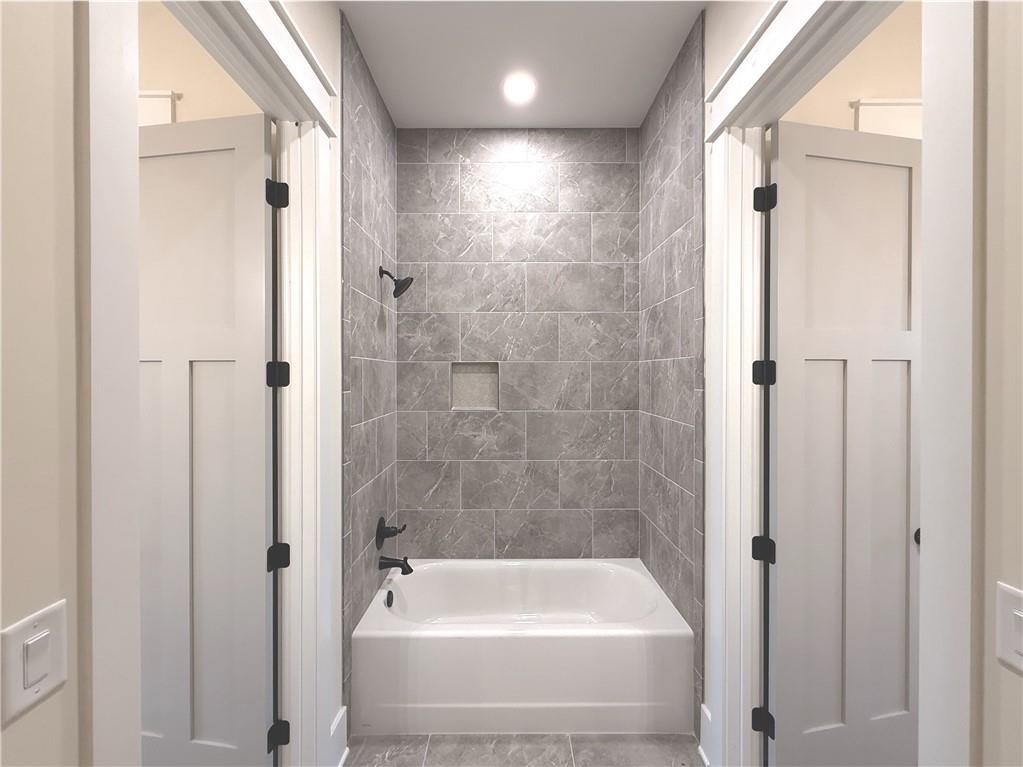 303 Eminence Peak Rydal, GA 30171 - Photo 59 of 73 a bathroom with a tub and shower
