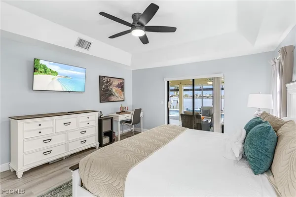 a bedroom with a bed and a painting on the wall