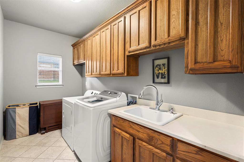 105 Country Ridge Court Red Oak, TX 75154 - Photo 33 of 40 a kitchen with a sink cabinets and a wooden floor