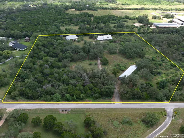 an aerial view of residential houses with outdoor space and swimming pool