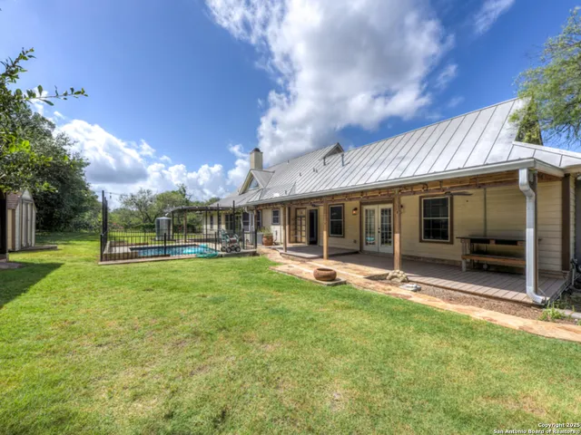 a view of hallway with couch and a ceiling fan
