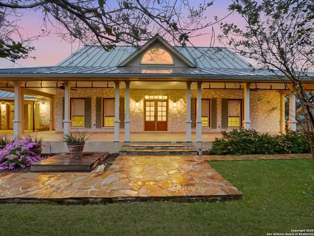 a view of an empty room with wooden floor and stairs