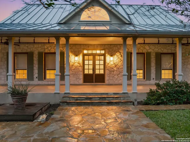 an empty room with wooden floor fireplace and windows