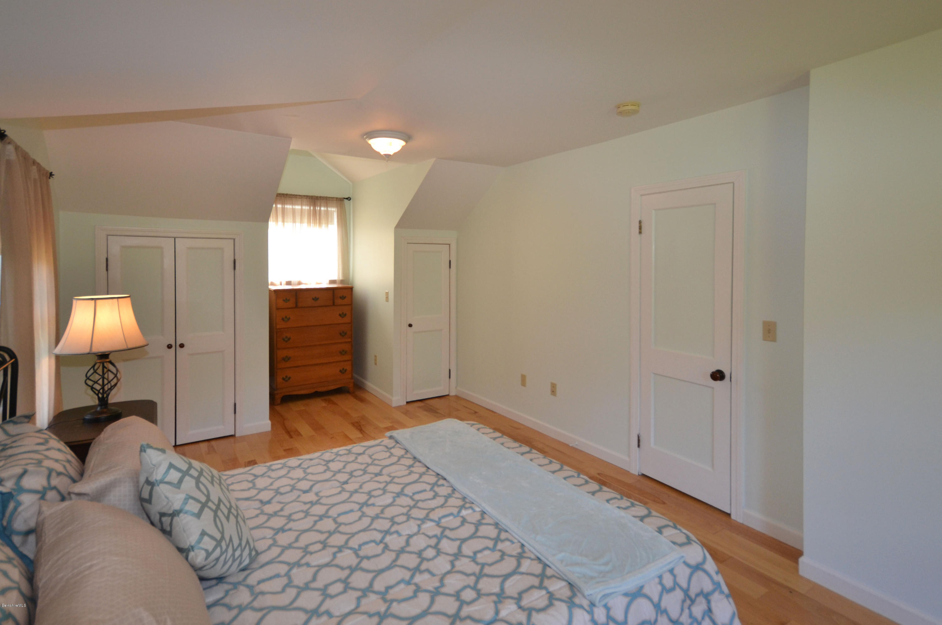 2127 Hancock Road Hancock, MA 01267 - Photo 27 of 53 a bedroom with a bed and a lamp