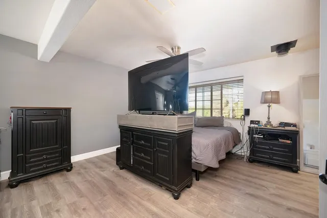 a bed room with a bed and a television