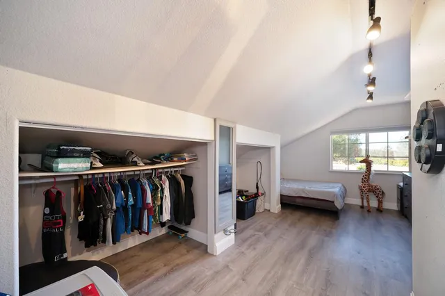 a view of a living room with clothes and a window