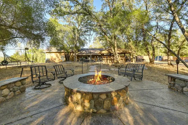 a backyard of a house with table and chairs