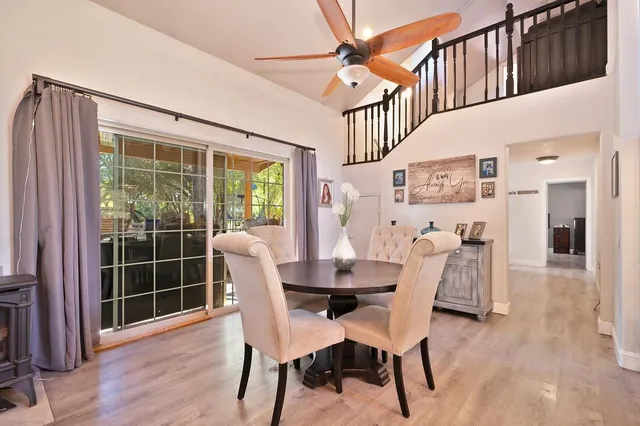a dining room with furniture window and wooden floor