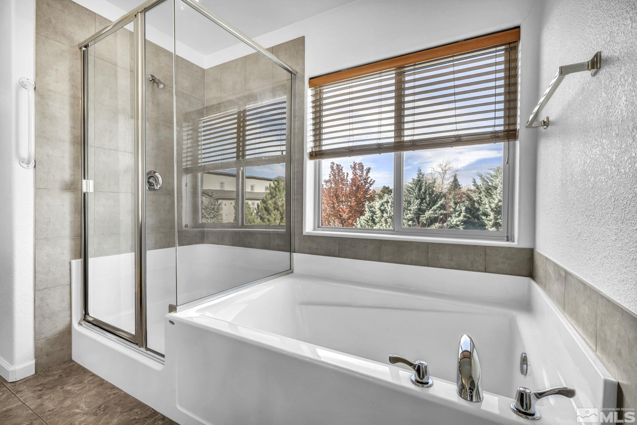 2705 Gulling Court Reno, NV 89503 - Photo 11 of 40 a bathroom with a bathtub and a shower