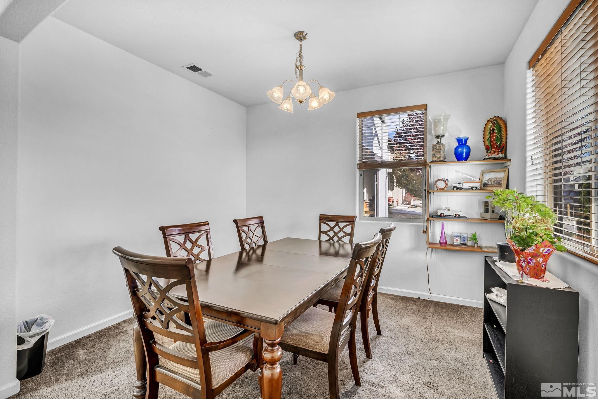 2705 Gulling Court Reno, NV 89503 - Photo 14 of 40 a view of a dining room with furniture and a chandelier