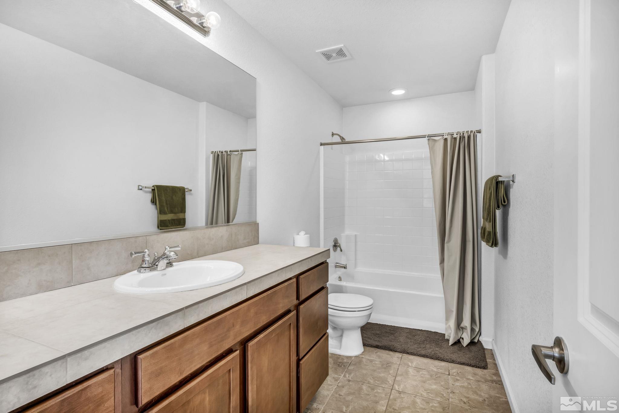 2705 Gulling Court Reno, NV 89503 - Photo 18 of 40 a bathroom with a granite countertop sink toilet and shower
