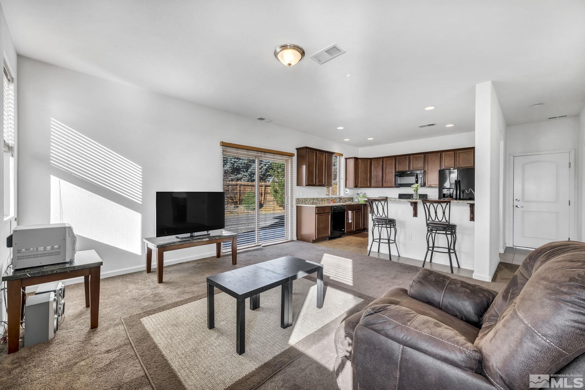 2705 Gulling Court Reno, NV 89503 - Photo 28 of 40 a living room with furniture a fireplace and a flat screen tv