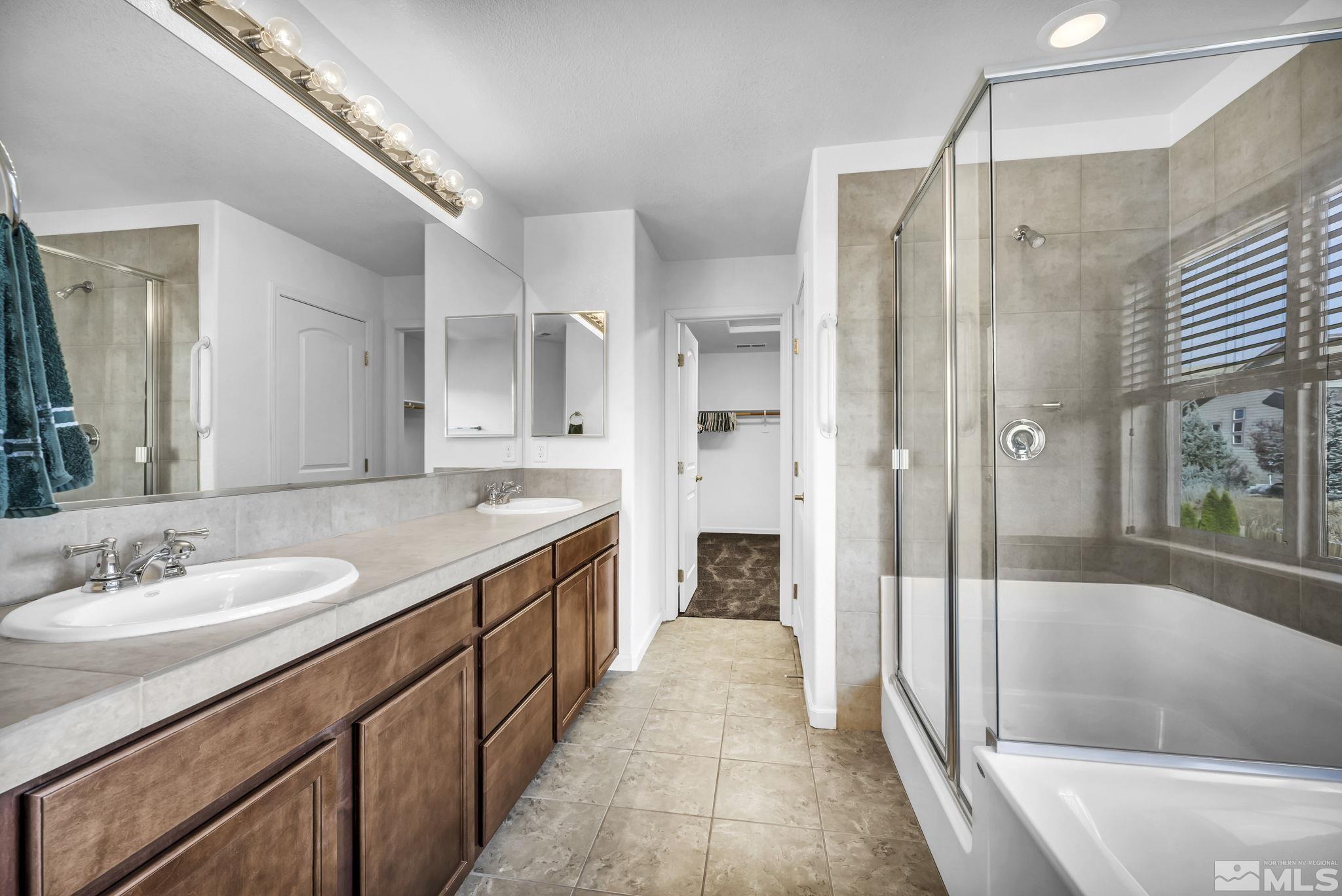 2705 Gulling Court Reno, NV 89503 - Photo 9 of 40 a spacious bathroom with a shower sink and a mirror