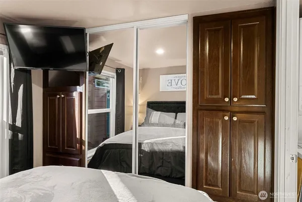 a bedroom with a bed and a mirror