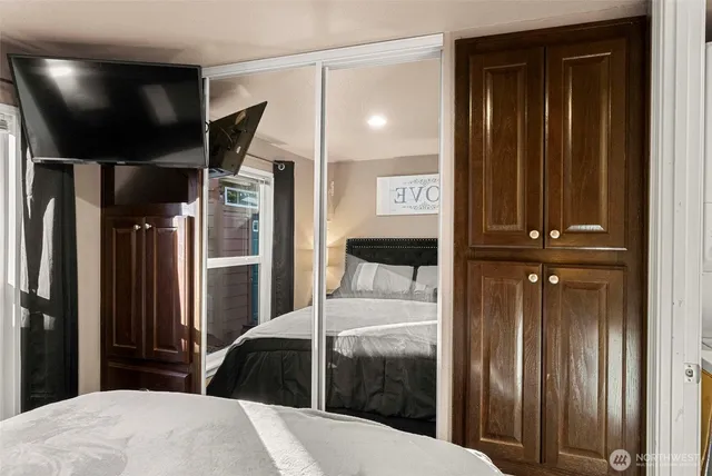 a bedroom with a bed and a mirror