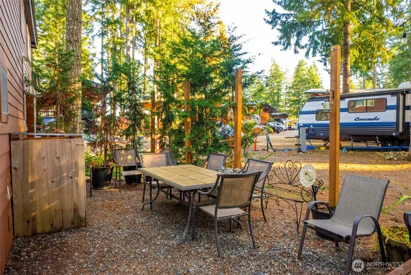a view of a patio with table and chairs and potted plants