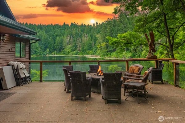 an outdoor view of a lake with furniture