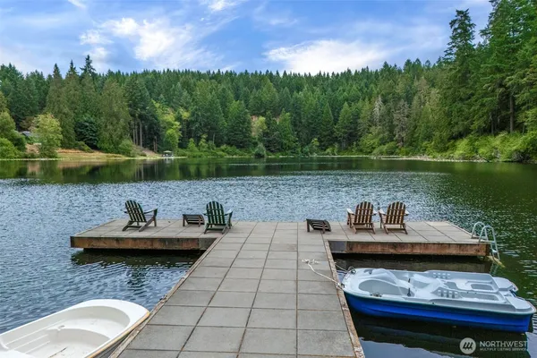 a view of a lake with couches and wooden floor