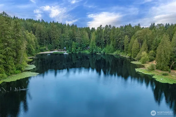 a view of a lake with a yard and mountain view