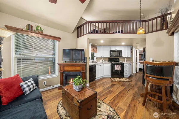a living room with fireplace furniture and a window