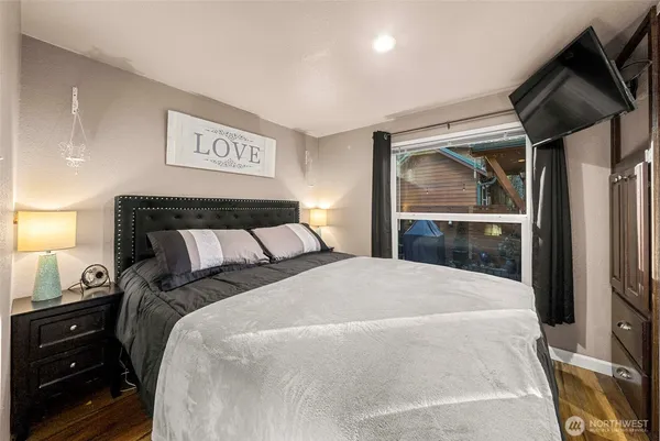 a bedroom with a bed and a mirror