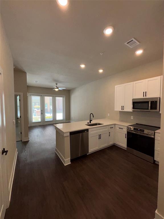 a large white kitchen with lots of counter space and a sink