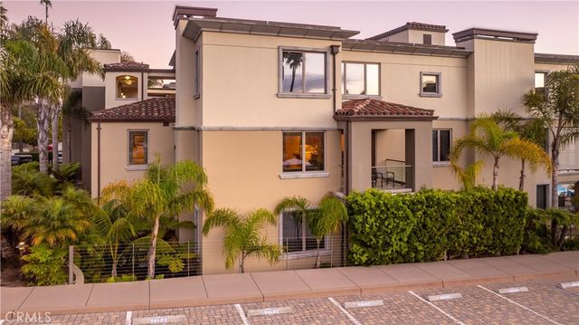 a kitchen with stainless steel appliances granite countertop a sink and a refrigerator