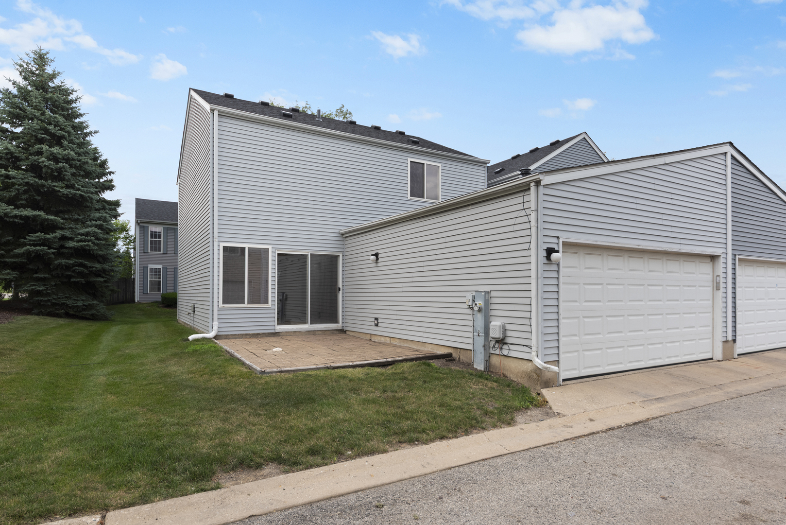 1011 Symphony Drive Aurora, IL 60504 - Photo 16 of 16 a view of a backyard with plants and large tree