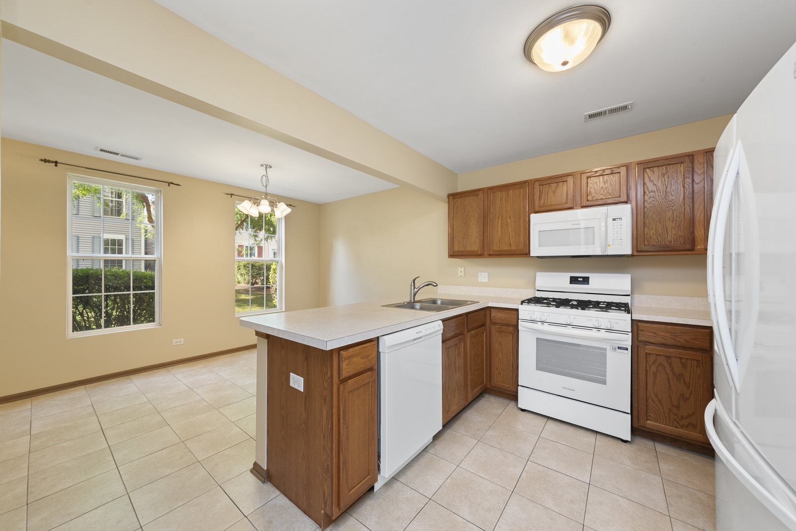 1011 Symphony Drive Aurora, IL 60504 - Photo 3 of 16 a kitchen with stainless steel appliances granite countertop a stove and a sink