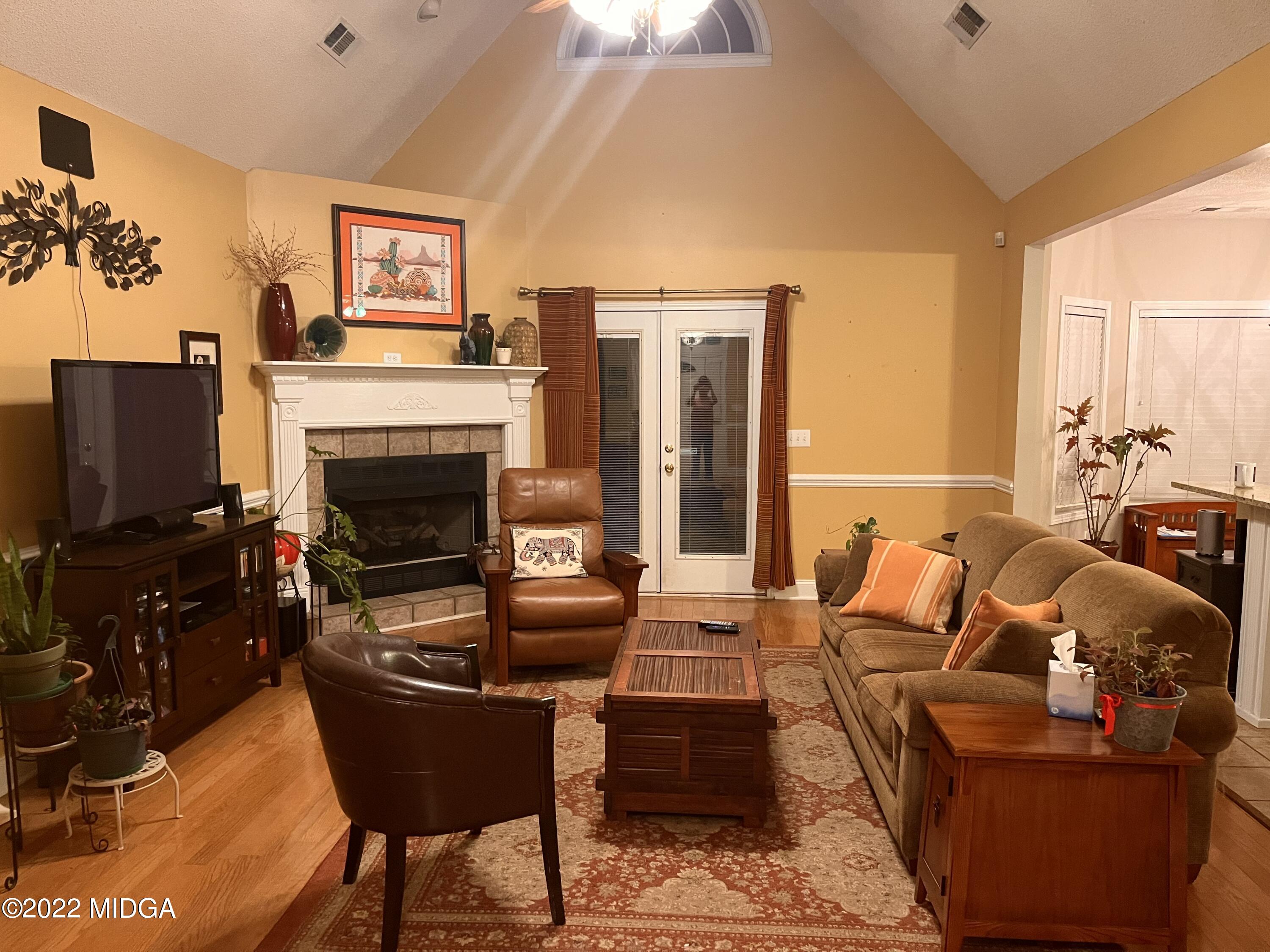 1277 Johnson Road Macon, GA 31220 - Photo 8 of 22 a living room with furniture a flat screen tv and a fireplace