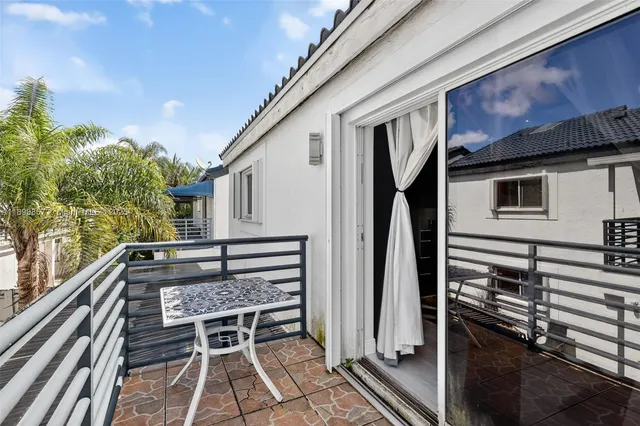 a balcony view with a outdoor seating space