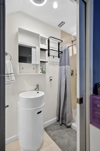 a bathroom with a sink a mirror and shower