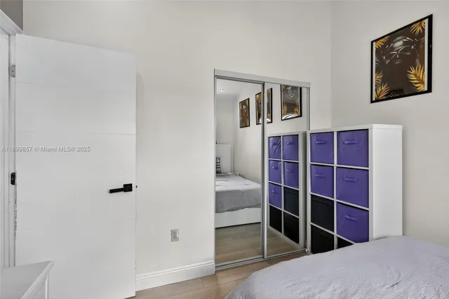 a view of empty room with wooden floor and closet