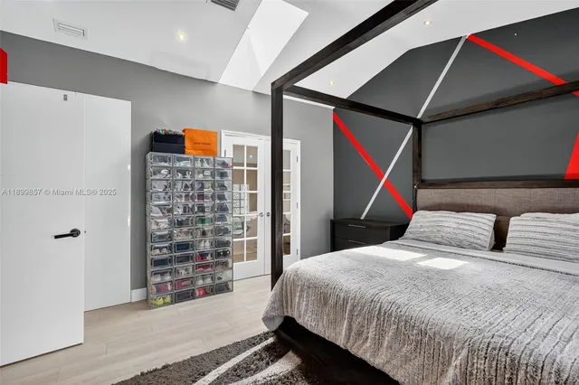 a bedroom with a bed and a wall painting