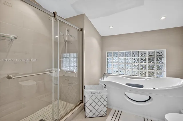 a bathroom with a bathtub and a shower
