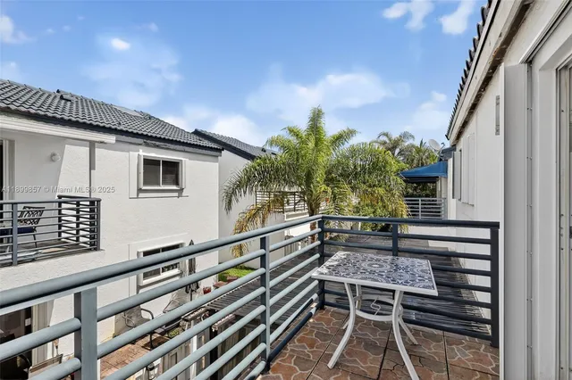 a backyard of a house with lots of green space and wooden fence