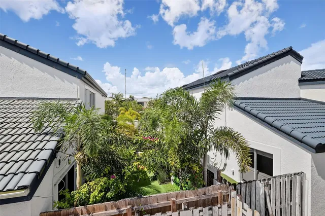 a view of a backyard with wooden fence