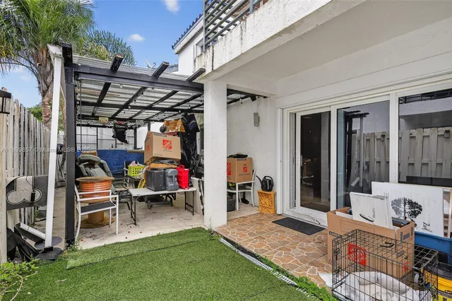 a view of a house with backyard and sitting area