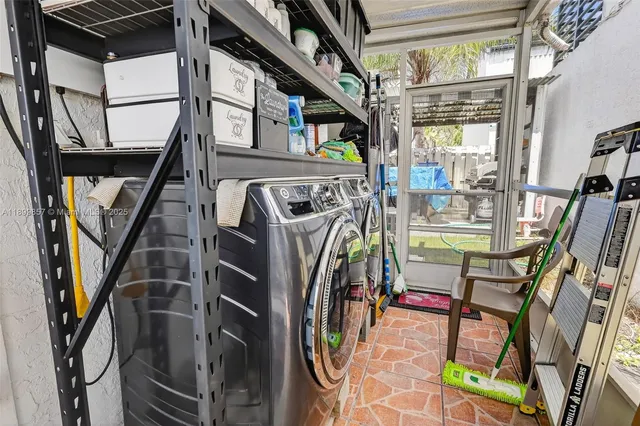 a living room with furniture a flat screen tv and a floor to ceiling window