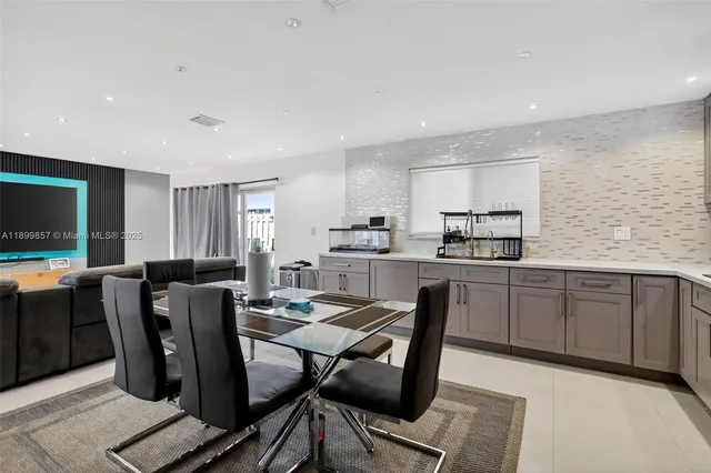 a living room with stainless steel appliances kitchen island granite countertop furniture and a kitchen view
