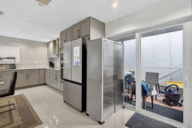 a kitchen with stainless steel appliances a refrigerator and a stove top oven