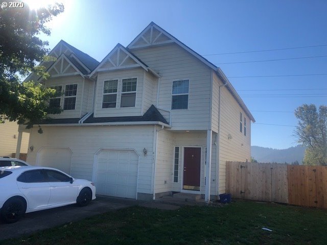 a front view of a house with a garden and yard
