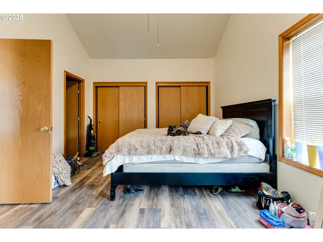 a bed sitting in a bedroom next to a window