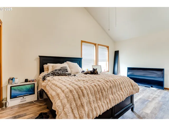 a bedroom with a bed and a night stand