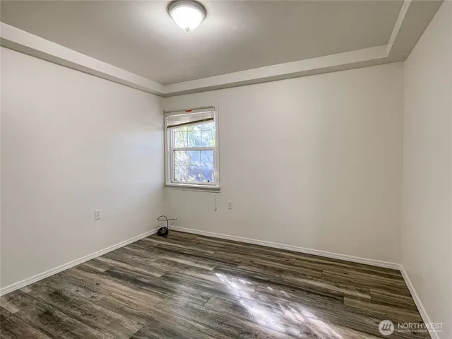 a view of a room with wooden floor and natural light
