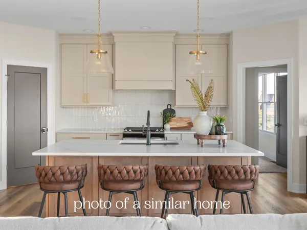 a kitchen with a table chairs and chandelier