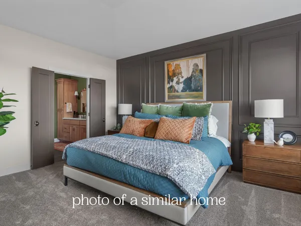 a bedroom with a bed and a painting on the wall