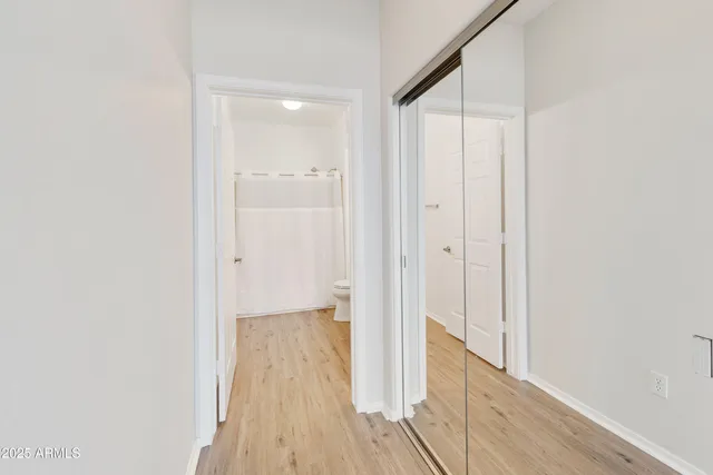 a view of a hallway with wooden floor