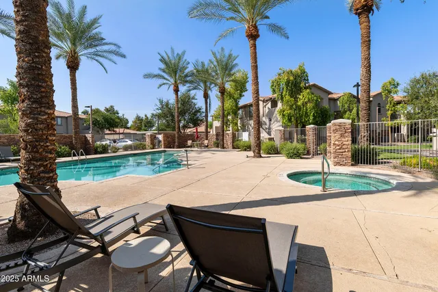 a swimming pool with outdoor seating and yard