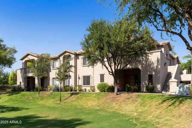 a yellow house with trees in front of it